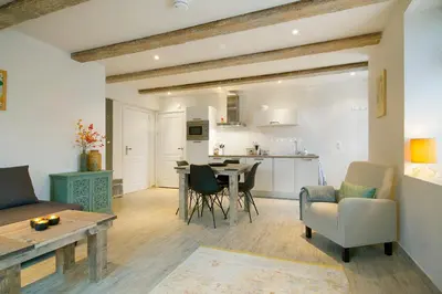 a living room and kitchen with a table and chairs at 