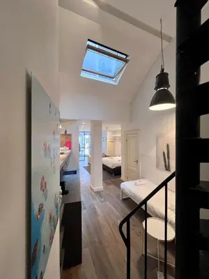 a living room with a bedroom and a bed at Spui apartment in center in Amsterdam