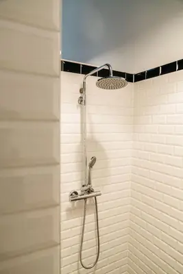 a shower with a shower head in a bathroom at Spui apartment in center in Amsterdam