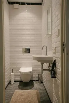 a white bathroom with a sink and a toilet at Spui apartment in center in Amsterdam