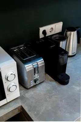 a toaster oven sitting on a counter with other appliances at Spui apartment in center in Amsterdam