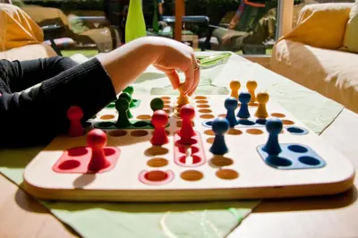 a person playing chess on a table at Ferienhaus Sonnenschein in Sint Maarten