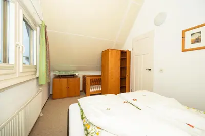 a bedroom with two beds and a window at Ferienhaus Sonnenschein in Sint Maarten