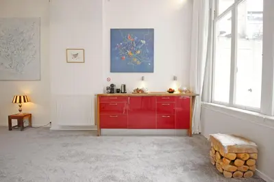 a red cabinet in a room with a window at Cozy Jordaan canalhouse near Anne Frank House in Amsterdam