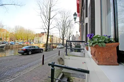 a pot of flowers on the side of a building at Cozy Jordaan canalhouse near Anne Frank House in Amsterdam
