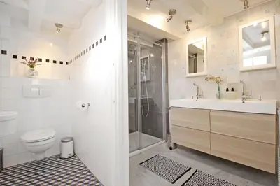 a bathroom with a shower and a toilet and a sink at Cozy Jordaan canalhouse near Anne Frank House in Amsterdam