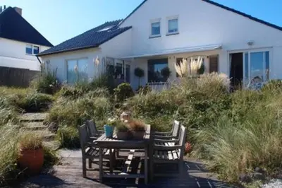 a table and chairs in front of a house at Villa 't Spokeduin in Zandvoort