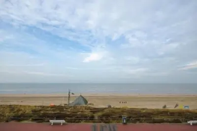 a view of a beach with a tent and the ocean at Villa 't Spokeduin in Zandvoort