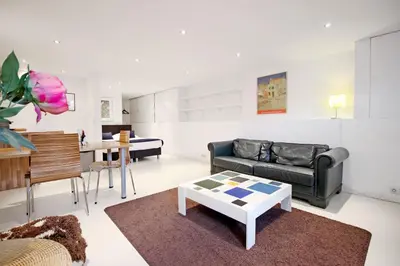 a living room with a couch and a table at Romantic Jordaan Canalsuite near Anne Frank House in Amsterdam