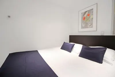 a bedroom with a large bed with blue pillows at Romantic Jordaan Canalsuite near Anne Frank House in Amsterdam