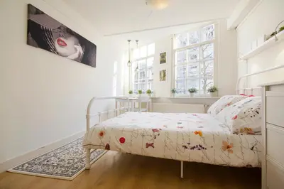 a bedroom with a bed and a window at Spui's the Limit in Amsterdam