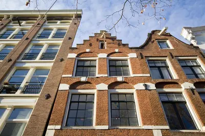 a brick building with arches on the side of it at Spui's the Limit in Amsterdam