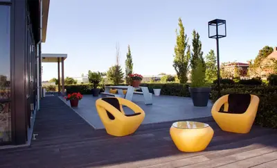 a group of yellow chairs sitting on a patio at als het golft in Roelofarendsveen