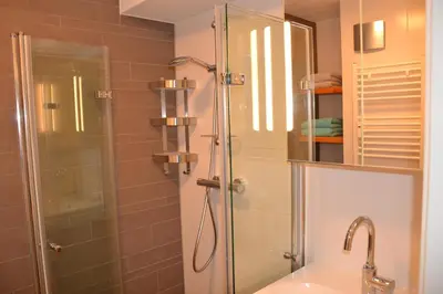 a bathroom with a shower and a sink at Beach Apartment Ikusasa in Zandvoort