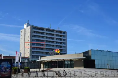 a large building with bikes parked in front of it at Beach Apartment Ikusasa in Zandvoort