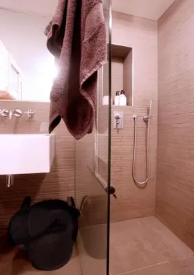 a shower with a glass door in a bathroom at Cozy Canal Studio in Amsterdam