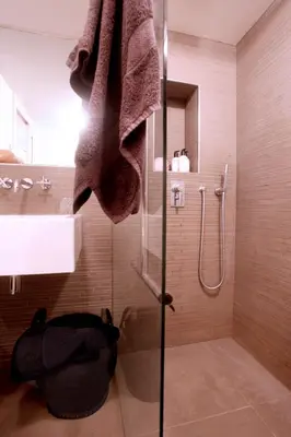 a bathroom with a shower with a glass door at Cozy Canal Studio in Amsterdam
