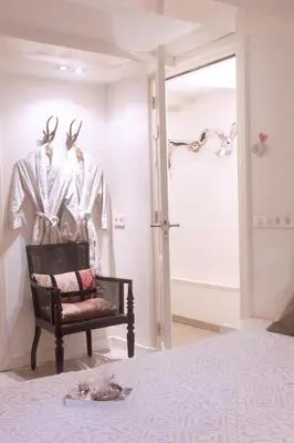 a room with a bed and a chair and a window at Cozy Canal Studio in Amsterdam