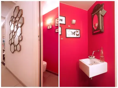 two pictures of a bathroom with red walls and a sink at Cozy Canal Studio in Amsterdam