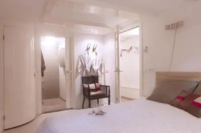 a bedroom with a bed with a cat laying on it at Cozy Canal Studio in Amsterdam