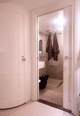 a bathroom with a glass door leading to a shower at Cozy Canal Studio in Amsterdam