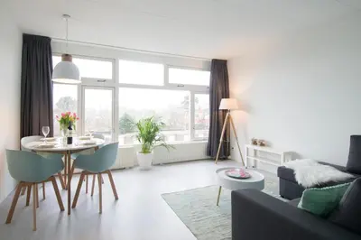 a living room with a table and a couch at Amsterdam Beach Apartment 80 in Zandvoort