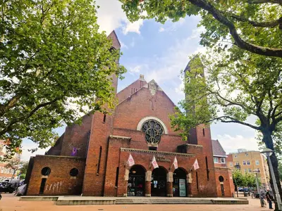 a large red brick church with a tower at Chasse Boutique Hotel in Amsterdam