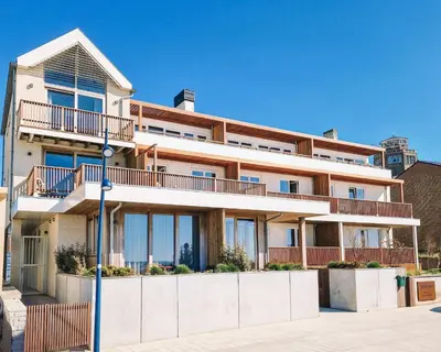 an apartment building with balconies on a street at Boulevard 5 in Zandvoort