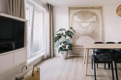 a living room with a table and a potted plant at Boulevard 5 in Zandvoort