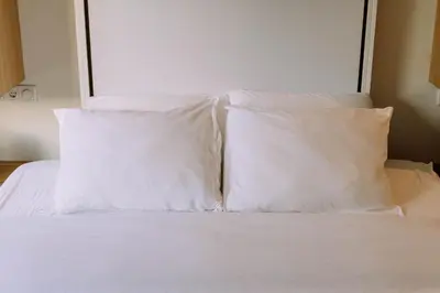two white pillows sitting on top of a bed at The Amsterdam Houseboat Family - de Jordaan Brand New Houseboat! in Amsterdam