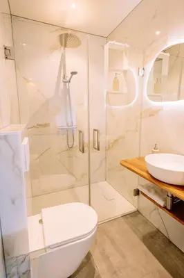 a bathroom with a shower and a toilet and a sink at The Amsterdam Houseboat Family - de Jordaan Brand New Houseboat! in Amsterdam