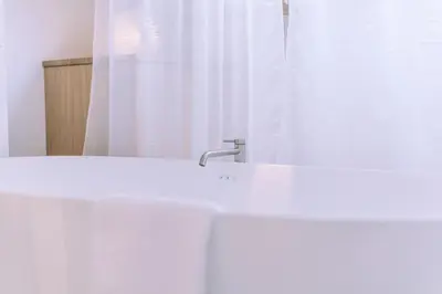 a bathroom with a white sink and a mirror at The Amsterdam Houseboat Family - de Jordaan Brand New Houseboat! in Amsterdam