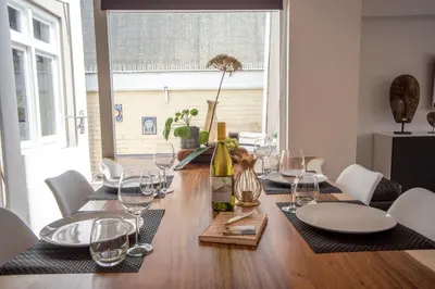 a dining room table with wine glasses on it at Sack-Time fashion boutique hotel 1 & 2 in Zandvoort