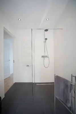a bathroom with a shower with a glass door at Sack-Time fashion boutique hotel 1 & 2 in Zandvoort