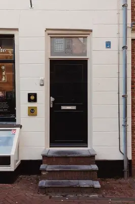 a black door on the side of a building at City Attic Haarlem in Haarlem