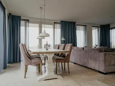 a dining room with a table and a couch at Apartment in Egmond aan Zee near the Beach in Egmond aan Zee