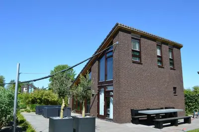 a brick building with a picnic table in front of it at Vakantiehuis Olivia in Schoorl