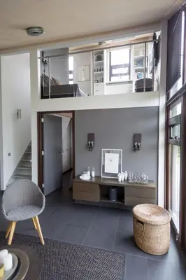a living room with a table and a chair at Vakantiehuis Olivia in Schoorl