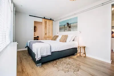 a bedroom with a large bed in a room at West 7 in Zandvoort
