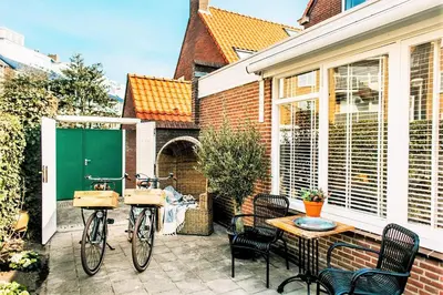 two bikes parked on a patio with a table and chairs at West 7 in Zandvoort