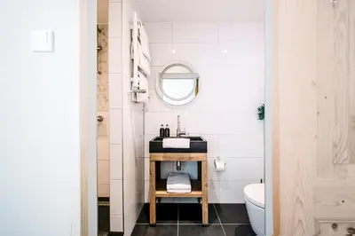 a bathroom with a sink and a mirror at West 7 in Zandvoort