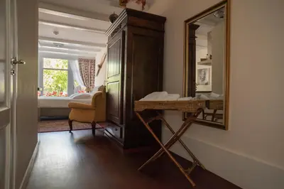 a bathroom with a dresser and a mirror at Keizershouse Amsterdam in Amsterdam
