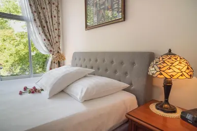 a bedroom with a bed with a window and a lamp at Keizershouse Amsterdam in Amsterdam