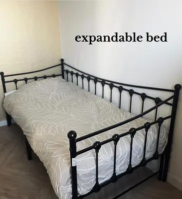 a bed in a room with a black frame at Apartment Marmoris in Zandvoort