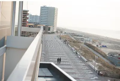 two people walking down the stairs to the beach at Apartment Marmoris in Zandvoort