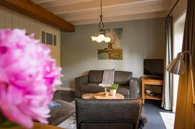 a living room with a couch and a table at Hoeve Suydeinde in Aarlanderveen