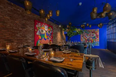 a dining room with a long wooden table and chairs at Leonardo Hotel Vinkeveen Amsterdam in Vinkeveen