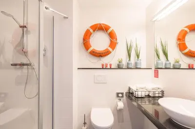 a bathroom with a sink and a toilet and a shower at Leonardo Hotel Vinkeveen Amsterdam in Vinkeveen