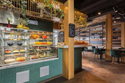 a bakery with a display case filled with pastries at Leonardo Hotel Vinkeveen Amsterdam in Vinkeveen