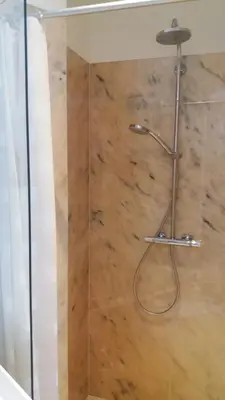 a shower with a glass door in a bathroom at Het Findament Tiny house in Hilversum